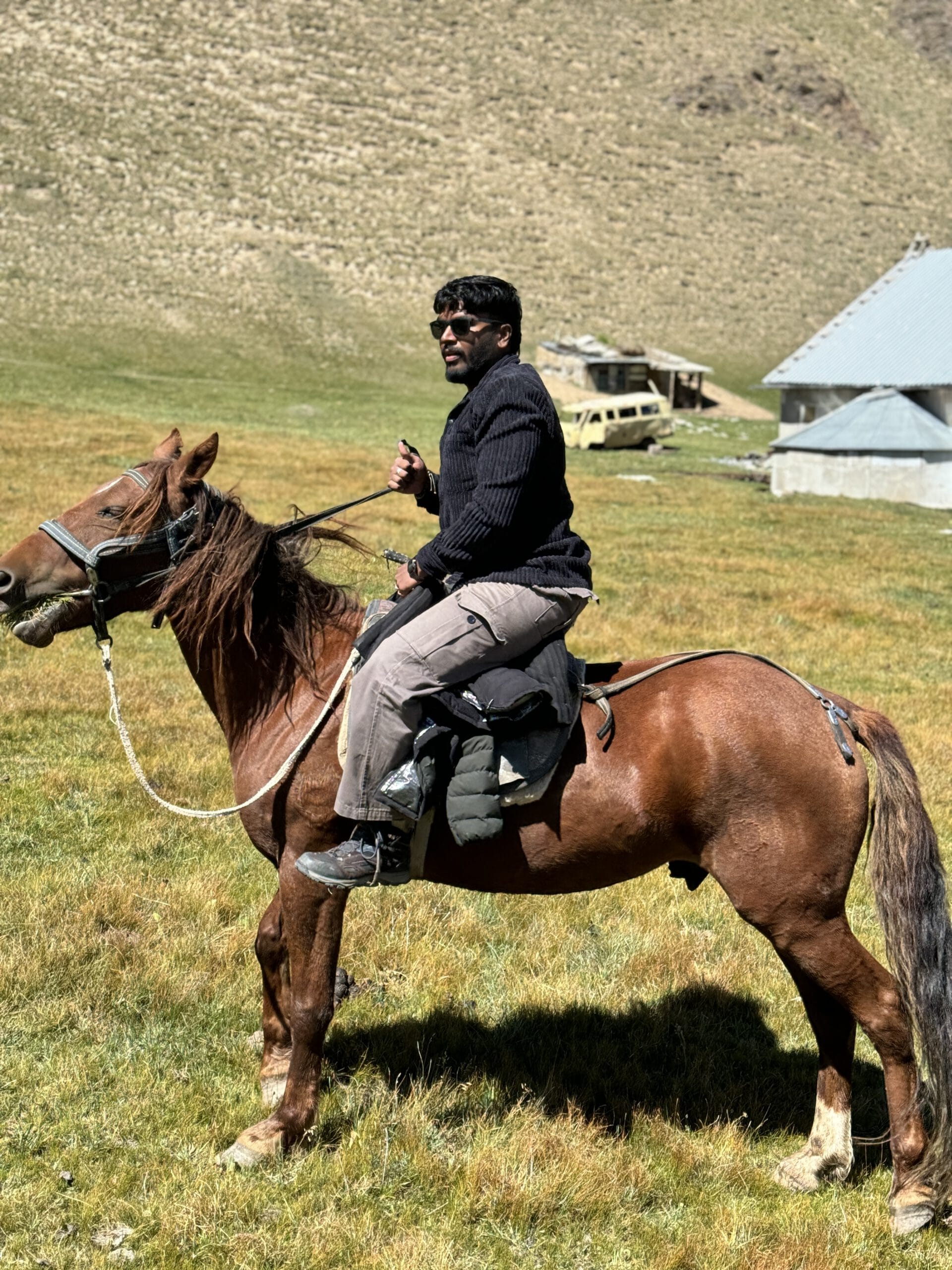 Horse riding through Kyrgyzstan open valleys